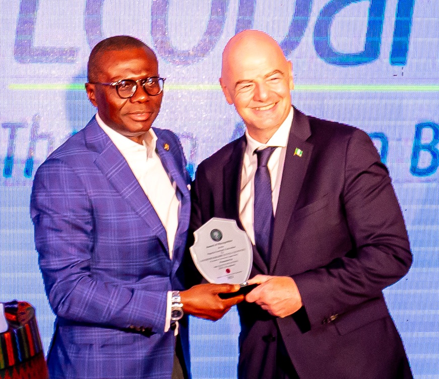 L-R: President of Nigeria Football Federation (NFF), Mr. Amaju Pinnick, Lagos State Governor, Mr. Babajide Sanwo-Olu receiving NFF award of recognition being presented by FIFA President, Mr. Giovanni Infantino during the NFF dinner reception in honour of the FIFA President at the Eko Hotels and Suites, Victoria Island, Lagos